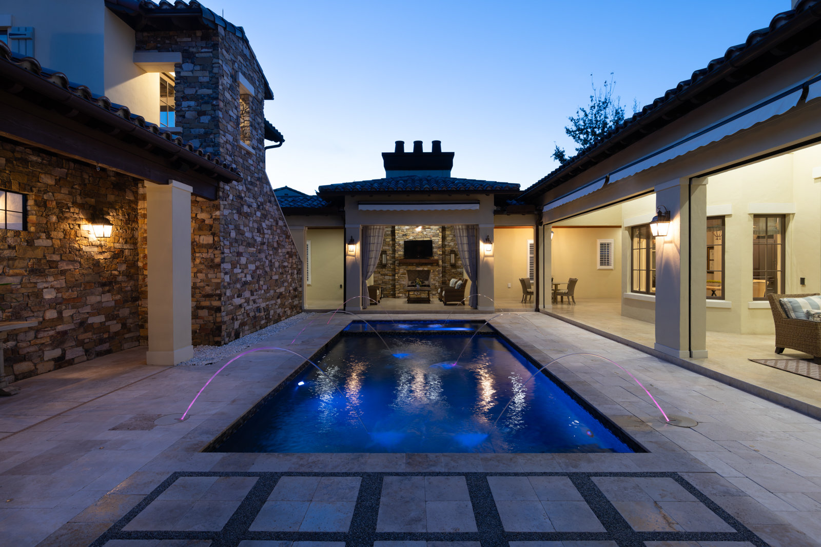 courtyard with pool and outdoor lighting
